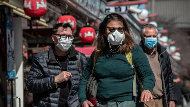 Tourists wear face masks as they visit Sensoji Temple on March 11, 2020 in Tokyo, Japan.