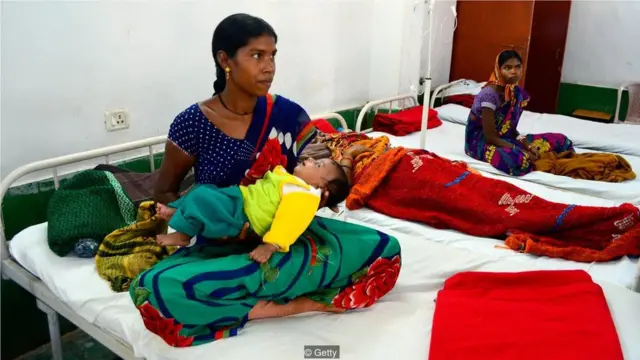 百伊(Anita Bai)是在2014年大規模絶育潮中,患併發症的其中一名女性。這場絶育潮使13位婦女喪生。百伊一邊在醫院接受治療,一邊照顧自己的孩子。(Credit: Getty)