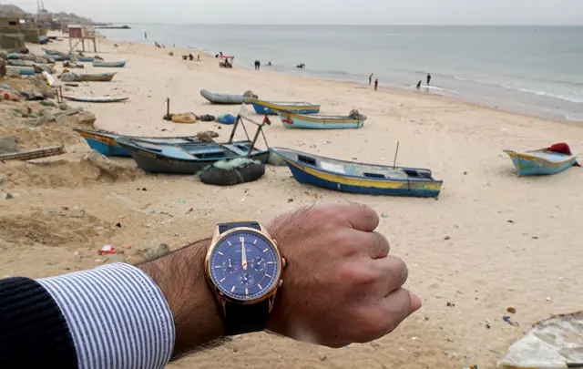 A watch showing the time at noon in front of a beach in the northern Gaza Strip, Palestinian Territories