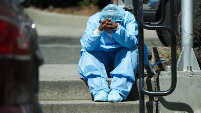 A tired healthcare worker is seen by the Brooklyn Hospital Center in New York, United States on April 1, 2020