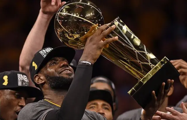 LeBron James holding aloft the NBA Championship trophy in 2016