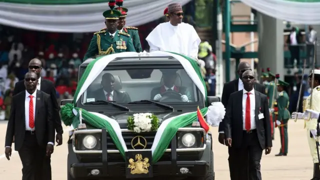 Nigerian President Muhammadu Buhari rides in an open car as he inspects the honour guards on parade to mark Democracy Day in Abuja, on June 12, 2019. - Nigeria celebrates the Day of Democracy on June 12, commemorating the country's first free elections, on June 12, 1993, after a decade of military rule. (Photo by PIUS UTOMI EKPEI / AFP) (Photo credit should read PIUS UTOMI EKPEI/AFP/Getty Images)