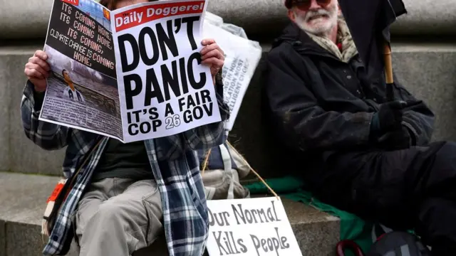 Climate activists sit in George Square ahead of the UN Climate Change Conference (COP26) in Glasgow, Scotland, Britain