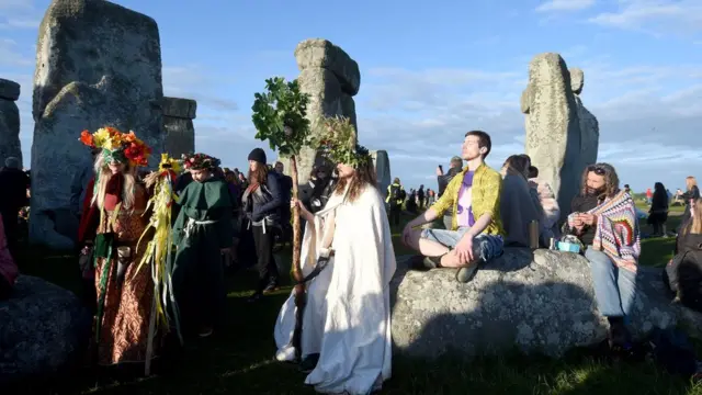 Visitors celebrate summer solstice and the dawn of the longest day of the year at Stonehenge on June 21, 2019 in Amesbury, England