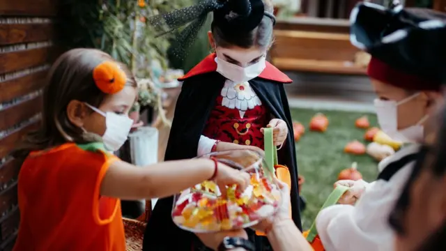 Children trick or treating with mask