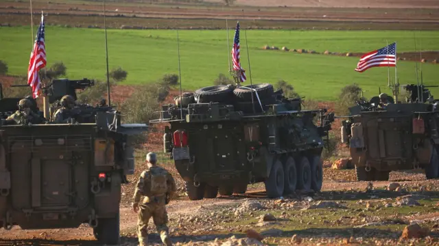 A convoy of US armoured vehicles drives near the village of Yalanli, on the western outskirts of the northern Syrian city of Manbij. March 5, 2017