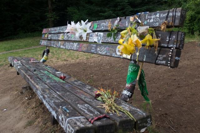 Украшенная цветами и граффити парковая скамейка, на которой любил сидеть Курт Кобейн, недалеко от его дома в Сиэтле, где он покончил с собой 5 апреля 1994 года.