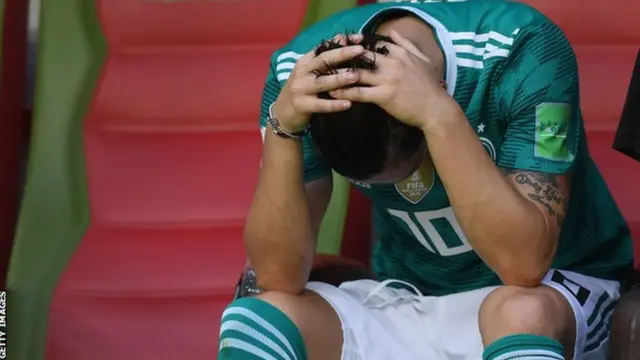 Mesut Ozil holds his head in his hands