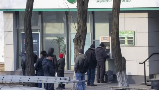 Citizens of Ukraine queue at ATMs in Kramatorsk city in eastern Ukraine's Donbas region on February 24, 2022.