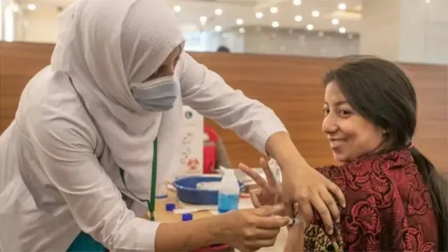 টিকা দিচছেন এক নারী।