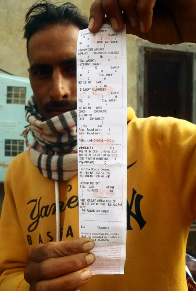 10 रुपये की बिजली बिल दिखाता एक युवक