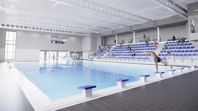 Imagen generada por computadora de una piscina con un hombre con pantalones cortos grises preparándose para saltar desde uno de los ocho bloques de salto. Al fondo se ven espectadores sentados en asientos azules.