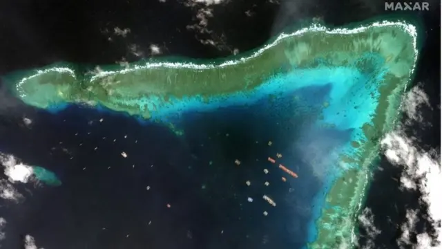 A handout satellite image made available by MAXAR Technologies shows Chinese vessels anchored at the Whitsun Reef in the disputed South China Sea on 23 March 2021 (issued 25 March 2021)