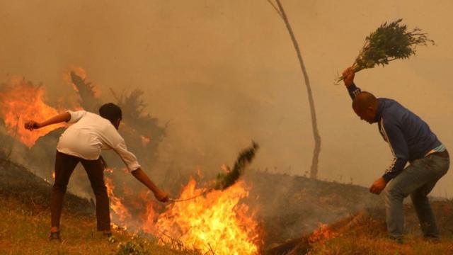 Residents of Baglung district in western Nepal battle forest fires