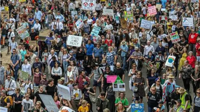 Protesters hold placards for Melbourne Australia