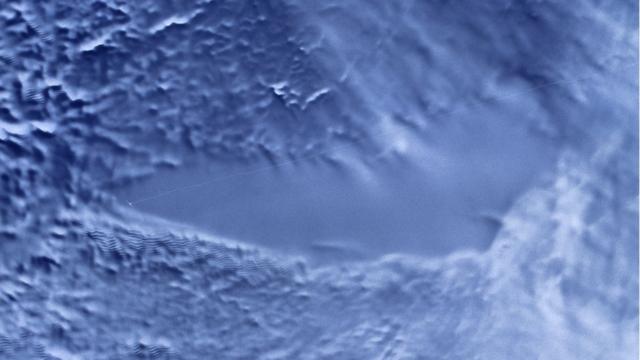 Satellite image of a flat region of ice, surrounded by more textured terrain