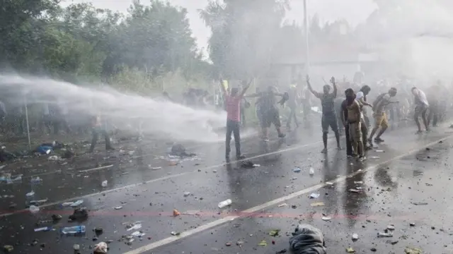 Hungarian police use water cannon at the border between Serbia and Hungary near Horgos, northern Serbia, 16 September 2015