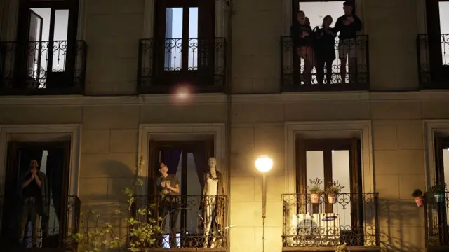 Gente aplaudiendo en los balcones.