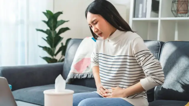 Woman holding her stomach in pain