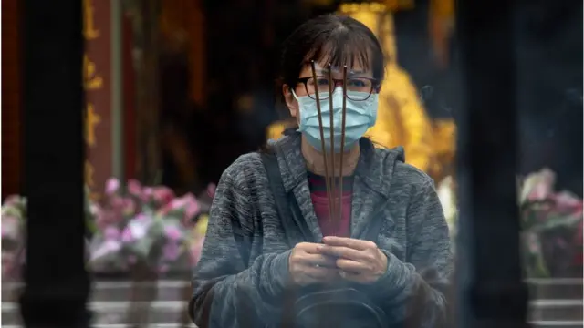 Taiwanese pray at a Chinese temple on March 18, 2020 in Taipei, Taiwan. Taiwan, Singapore and Hong Kong have had more successful approaches in battling the pandemic given their experience with SARS in 2003