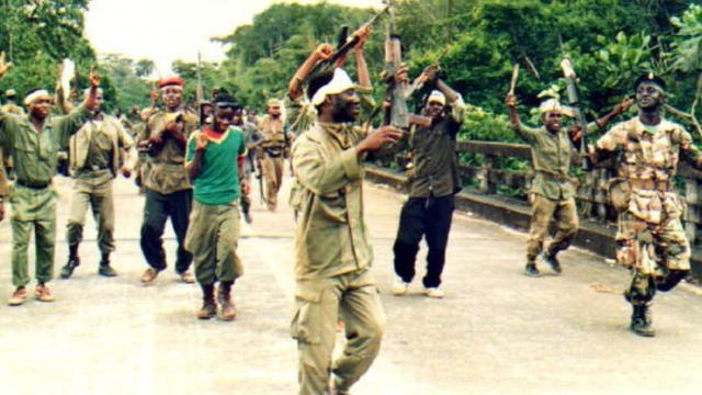 Fighters from United Liberation Movement (ULIMO) dey do war dance on top Po River bridge 02 September, 1992 for Monrovia.