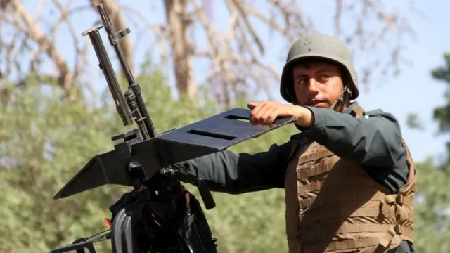 An Afghan security official patrol after they took back control of parts of Herat city following intense battle with Taliban militants