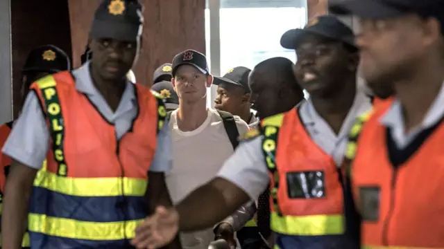 Former captain Steve Smith (C) of the Australian Cricket Team departs at O R Tambo International Airport after being caught cheating in the Sunfoil Test Series between Australia and South Africa, on March 28, 2018 in Johannesburg.