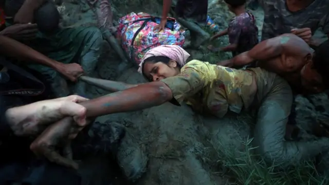 A Rohingya refugee trying to cross the Nad River. the crossing point between the Myanmar-Bangladesh border in Palong Khali, near Cox's Bazar.