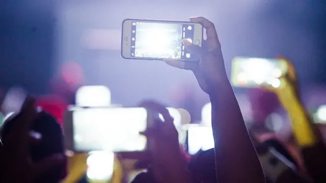 شباب يحملون هواتف محمولة