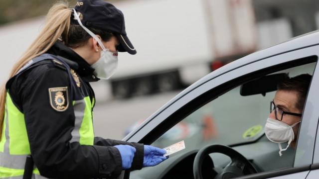 Police check a car entering Spain from France at La Jonquera