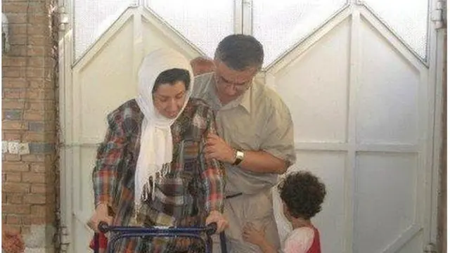 تقی رحمانی در حال کمک به همسرش نرگس محمدی که به دلیل فشار عصبی در زندان در اوایل دهه نود خورشیدی دچاز فلج عضلانی شده بود