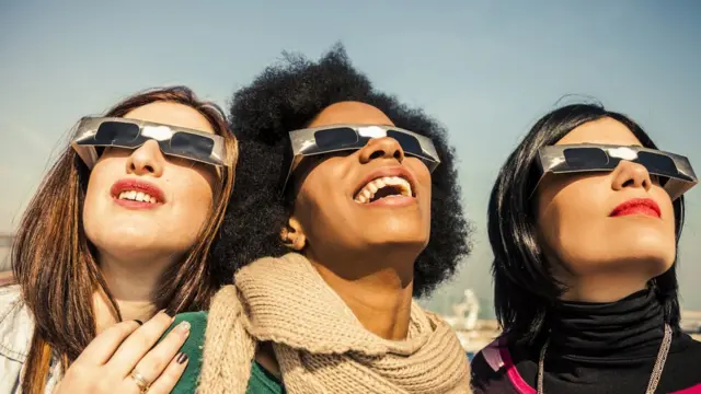 Jóvenes mirando un eclipse