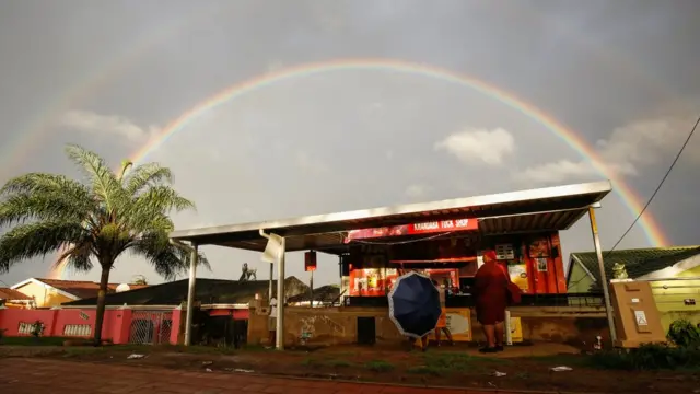 A rainbow is seen briefly after flooding in Inanda, Durban, South Africa, April 13, 2022.