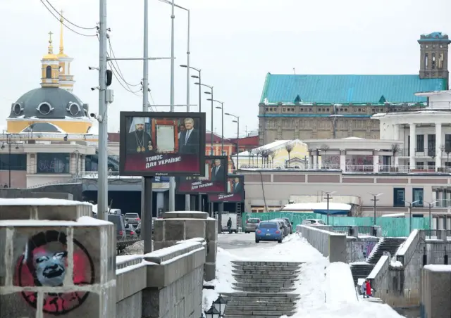 постеры с изображением Епифания и Петра Порошенко на фоне томоса