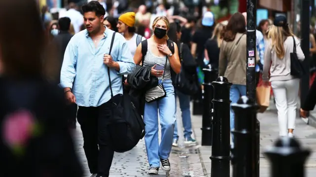 Woman in a mask on a busy London street