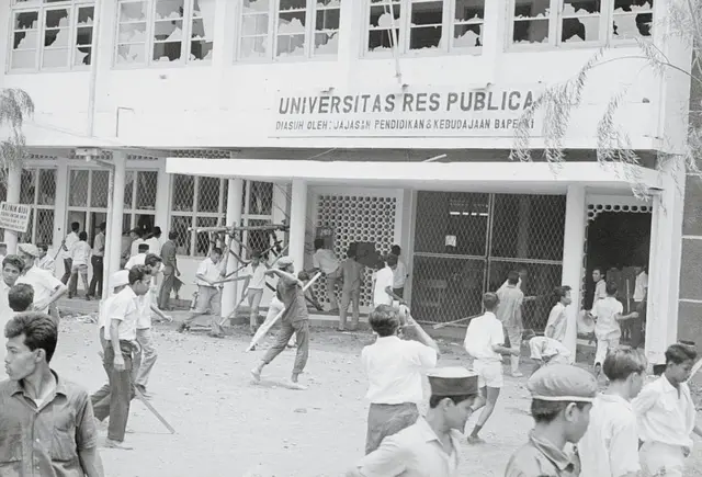 Massa merusak salah-satu bangunan di kompleks Universitas Res Publica di Jakarta, 12 Oktober 1965.