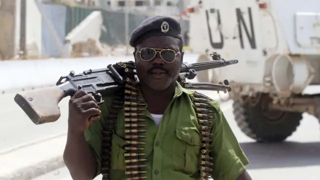 A policeman walks towards the scene of a suicide bombing near the African Union's main peacekeeping base in Mogadishu, Somalia - Tuesday 26 July 2016