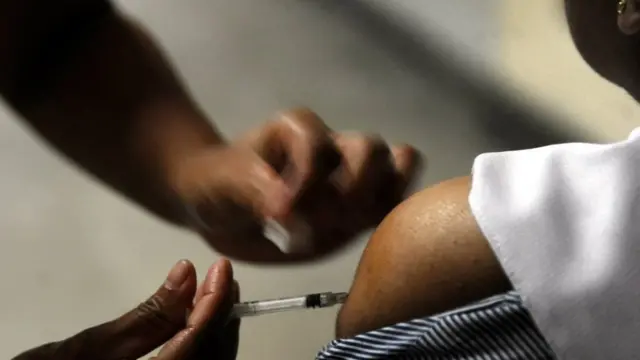 A Sri Lankan nurse injects a vaccine against the H1N1 or swine flu influenza at a hospital in Colombo on December 29, 2010. The Health Ministry said swine flu has killed 22 people and infected 371 people over the past two months. It blamed recent heavy rains and the onset of cold weather for spreading the influenza that affects peoples' lungs and triggers off a strain of viral pneumonia. AFP PHOTO/Ishara S. KODIKARA (Photo credit should read Ishara S.KODIKARA/AFP/Getty Images)