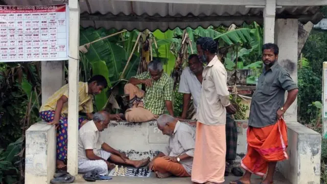 Pobladores de Marottichal presenciando una partida de ajedrez en la calle