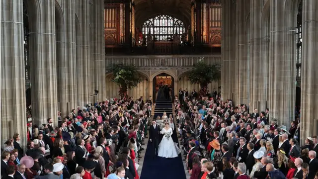 Princess Eugenie of York and Mr. Jack Brooksbank walk down the aisle after they were married at St. George"s Chapel