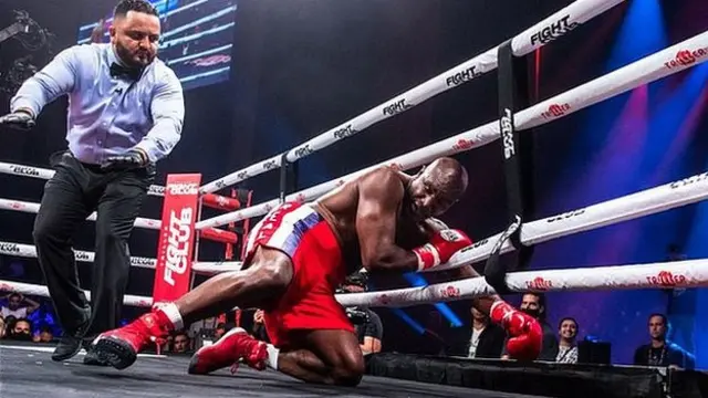 Evander Holyfield is knocked down by Vitor Belfort during the first round of the fight during Evander Holyfield vs. Vitor Belfort presented by Triller at Seminole Hard Rock Hotel & Casino on September 11, 2021 in Hollywood, Florida.