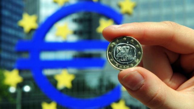 Монета на фоне Европейского центробанка