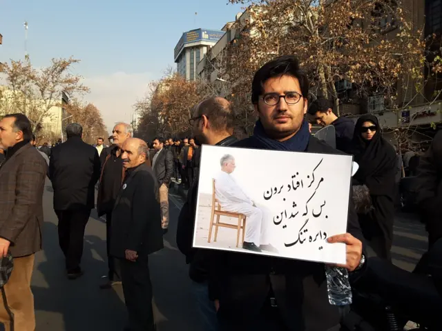 یکی از شرکت کنندگان در مراسم مقابل دانشگاه تهران