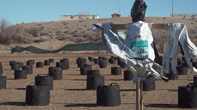 A scarecrow in the midst of cannabis cultivation pots at a farm in Shiprock, New Mexico