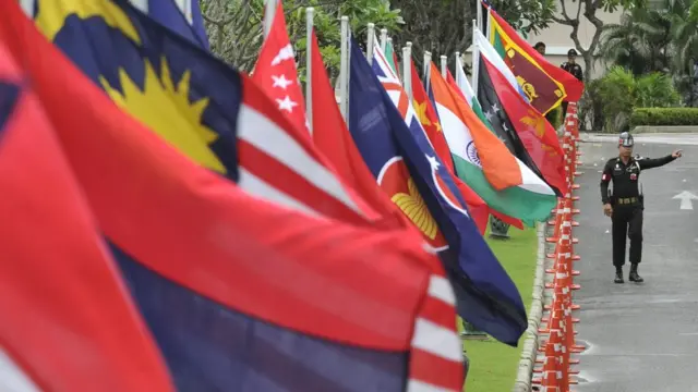 A Thai soldier gestures from his position securing a road lined with the flags of member countries of Association of Southeast Asian Nations (ASEAN) and regional dialogue partner countries at the conference venue in the Thai resort island of Phuket on July 21, 2009