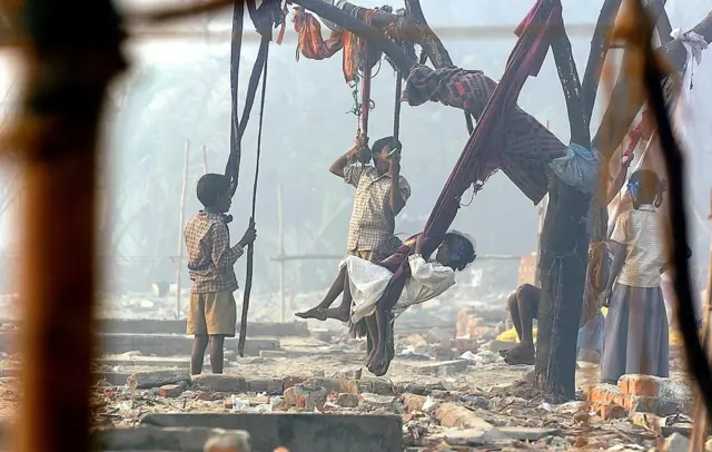 சென்னை நொச்சிக்குப்பத்தில் சுனாமி ஏற்படுத்திய பாதிப்பின் சுவடு மறையாத இடத்தில், உற்சாகமாக விளையாடும் குழந்தைகள்.