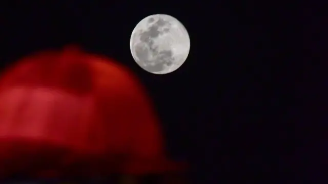 the moon during the Dubai World Cup horse race in the Meydan Racecourse on March 31, 2018 in Dubai.