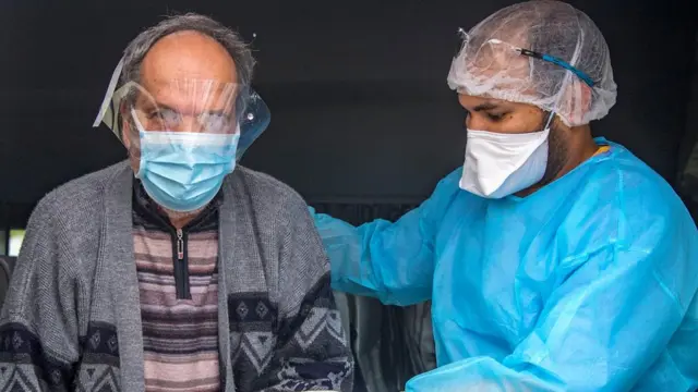 A patient who recovered from the Covid-19 leaves hospital in the city of Sale, Morocco