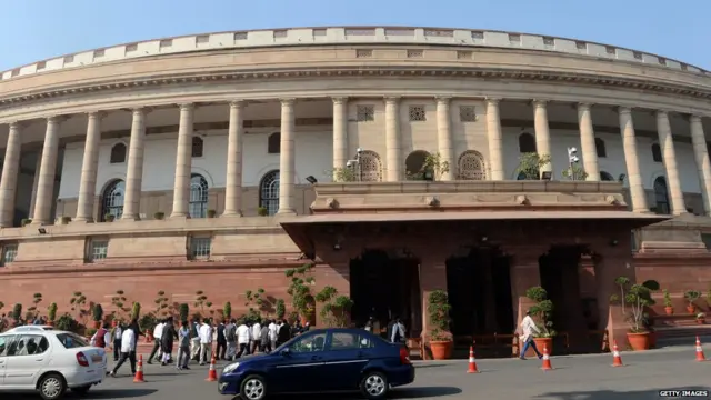 isitors walk outside at the opening of the Winter session of Parliament in New Delhi on December 5, 2013.