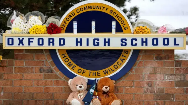 Stuffed bears and flowers are gathered at a makeshift memorial outside of Oxford High School